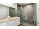 Modern bathroom with a double sink vanity, a large mirror, and a walk-in shower featuring glass doors at 45 Ivan Allen Jr Nw Blvd # 2705, Atlanta, GA 30308