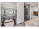 The bathroom is complete with a soaking tub, large mirrors, and glass enclosed shower at 45 Ivan Allen Jr Nw Blvd # 2705, Atlanta, GA 30308