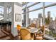 Bright dining area with city views features a modern round table with seating for upscale urban living at 45 Ivan Allen Jr Nw Blvd # 2705, Atlanta, GA 30308