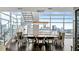 Elegant dining room with a long table, staircase, and stunning city views through large windows at 45 Ivan Allen Jr Nw Blvd # 2705, Atlanta, GA 30308