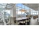 Bright dining room with large windows, modern chandelier, and a grand piano at 45 Ivan Allen Jr Nw Blvd # 2705, Atlanta, GA 30308