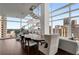 Bright dining area with city views features modern chandelier and staircase for upscale urban living at 45 Ivan Allen Jr Nw Blvd # 2705, Atlanta, GA 30308