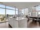 Bright kitchen featuring modern design with a center island, staircase, and expansive city views at 45 Ivan Allen Jr Nw Blvd # 2705, Atlanta, GA 30308