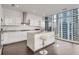 Contemporary white kitchen featuring an island with seating and large windows showcasing the cityscape at 45 Ivan Allen Jr Nw Blvd # 2705, Atlanta, GA 30308