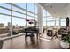 Bright living room with city views features a grand piano and modern art for upscale urban living at 45 Ivan Allen Jr Nw Blvd # 2705, Atlanta, GA 30308