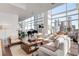 Bright living room featuring a modern design, floor-to-ceiling windows, and a grand piano overlooking the city at 45 Ivan Allen Jr Nw Blvd # 2705, Atlanta, GA 30308