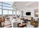 Bright living room with city views features a modern sectional and upscale design at 45 Ivan Allen Jr Nw Blvd # 2705, Atlanta, GA 30308