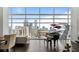 Elegant living room with floor-to-ceiling windows offering panoramic city views, complemented by a grand piano at 45 Ivan Allen Jr Nw Blvd # 2705, Atlanta, GA 30308