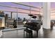 Modern living room showcasing floor-to-ceiling windows with stunning city views and a grand piano at 45 Ivan Allen Jr Nw Blvd # 2705, Atlanta, GA 30308