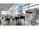 Bright living room with piano and city views features a modern art and upscale design at 45 Ivan Allen Jr Nw Blvd # 2705, Atlanta, GA 30308