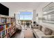 Bright home office with city views features a modern desk and built-in bookshelves at 45 Ivan Allen Jr Nw Blvd # 2705, Atlanta, GA 30308