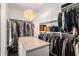 Bright walk-in closet featuring custom built-in shelving, drawers, and center island at 45 Ivan Allen Jr Nw Blvd # 2705, Atlanta, GA 30308