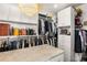 Spacious walk-in closet with custom shelves, drawers, and a glamorous chandelier at 45 Ivan Allen Jr Nw Blvd # 2705, Atlanta, GA 30308