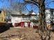 Backyard view of distressed house with boarded windows and damaged siding at 592 Formwalt Sw St, Atlanta, GA 30312