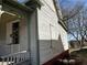 Exterior view of a distressed home showing the side and partial porch with weathered siding at 592 Formwalt Sw St, Atlanta, GA 30312