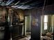 Damaged living room featuring exposed ceiling and walls needing renovation at 592 Formwalt Sw St, Atlanta, GA 30312