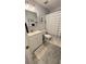 Well-lit bathroom with a combination tub and shower, white vanity, and neutral tile flooring at 672 Mcgill Ne Pl # 672, Atlanta, GA 30312