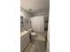 Neat bathroom featuring tub, shower and single sink vanity with modern fixtures at 672 Mcgill Ne Pl # 672, Atlanta, GA 30312