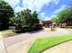 View of the community entrance, featuring brick sidewalks and lush landscaping at 672 Mcgill Ne Pl # 672, Atlanta, GA 30312