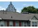 A townhouse with a gray roof and a view of the city skyline in the background at 672 Mcgill Ne Pl # 672, Atlanta, GA 30312