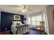 Comfortable bedroom with brass bed frame, ceiling fan and natural light from the windows at 672 Mcgill Ne Pl # 672, Atlanta, GA 30312