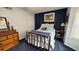 Comfortable bedroom featuring a brass bed frame, dark accent wall and plenty of natural light at 672 Mcgill Ne Pl # 672, Atlanta, GA 30312