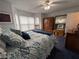 Bright bedroom with a brass bed frame, bay window, ceiling fan and an armoire at 672 Mcgill Ne Pl # 672, Atlanta, GA 30312