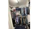 Organized walk-in closet with shelving, hanging rods, and a variety of clothing and shoes at 672 Mcgill Ne Pl # 672, Atlanta, GA 30312