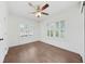 Well-lit bedroom featuring wood floors, a ceiling fan, two windows, and white walls at 1831 Dresden Dr, Brookhaven, GA 30319