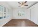 Inviting bedroom features hardwood floors, ceiling fan, large windows, and double closet at 1831 Dresden Dr, Brookhaven, GA 30319
