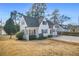 Quaint cottage style home with lush green landscaping and mature trees at 1831 Dresden Dr, Brookhaven, GA 30319