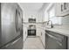 Well-lit kitchen featuring stainless steel appliances, white cabinetry, and modern subway tile backsplash at 1831 Dresden Dr, Brookhaven, GA 30319