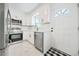 Compact kitchen with stainless steel appliances, white cabinets, and ample light at 1831 Dresden Dr, Brookhaven, GA 30319