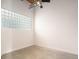 Bright bedroom featuring a unique glass block window and modern ceiling fan at 204 Walker Sw St # 319, Atlanta, GA 30313