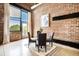 Dining area with modern table, exposed brick wall, and ample natural light at 204 Walker Sw St # 319, Atlanta, GA 30313