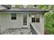 The back of the home featuring a deck, siding, a door with glass, and an outdoor light at 26 Nottingham Nw Dr, Cartersville, GA 30121