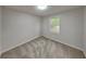 Cozy bedroom with natural light, neutral carpet, and standard window to enhance comfort at 26 Nottingham Nw Dr, Cartersville, GA 30121