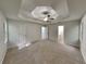 Spacious main bedroom with large ceiling fan and tray ceiling, offering ample room at 26 Nottingham Nw Dr, Cartersville, GA 30121