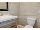 Modern bathroom with a stylish vanity, mirror, a toilet, and gorgeous tile flooring and walls at 3967 Norman Rd, Stone Mountain, GA 30083