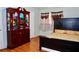 Comfortable bedroom with hardwood floors, a queen bed, a dresser, and a lovely red armoire for storage at 3967 Norman Rd, Stone Mountain, GA 30083