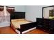 Spacious bedroom features hardwood floors, a queen size bed, and a matching dresser with a mirror for ample storage at 3967 Norman Rd, Stone Mountain, GA 30083