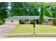Charming brick ranch home with a well-maintained front lawn and mature trees at 3967 Norman Rd, Stone Mountain, GA 30083