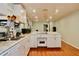 Spacious kitchen featuring white cabinets, wood floors, and modern appliances at 3967 Norman Rd, Stone Mountain, GA 30083