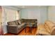 Inviting living room with hardwood floors, a cozy couch, a table, and lots of natural light from large windows at 3967 Norman Rd, Stone Mountain, GA 30083