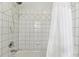 Close-up of bathtub with white tile and shower head at 4011 Charrwood Trce, Marietta, GA 30062