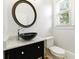 Stylish powder room with a vessel sink, marble countertop, and modern fixtures at 4011 Charrwood Trce, Marietta, GA 30062