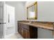 Bathroom with long granite countertop and wood cabinets at 4011 Charrwood Trce, Marietta, GA 30062