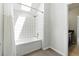 Bathroom with white tile and shower/tub combo with skylight at 4011 Charrwood Trce, Marietta, GA 30062