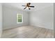 Cozy bedroom with natural light, neutral color palette, and wood-look flooring at 4011 Charrwood Trce, Marietta, GA 30062