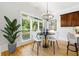 Charming breakfast nook with a modern chandelier, bright windows, and counter seating offering natural light at 4011 Charrwood Trce, Marietta, GA 30062